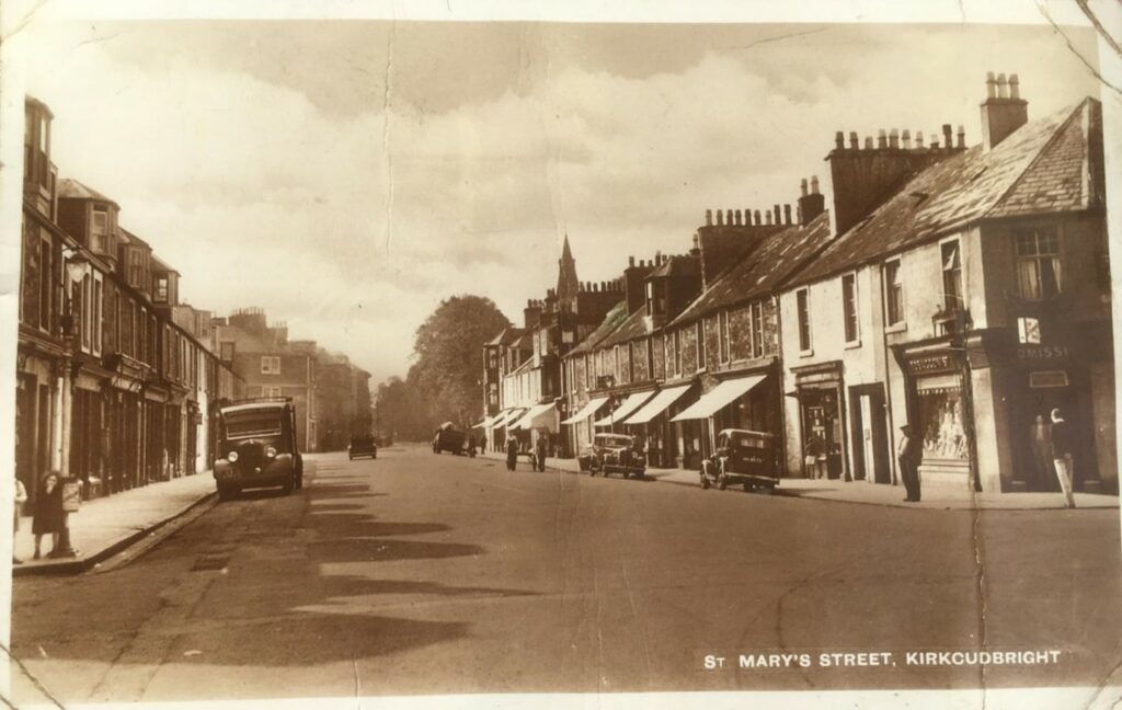 A wartime postcard of St Mary’s Street, Kirkcudbright, Scotland, dated 17th July 1942, showing a street with shops.